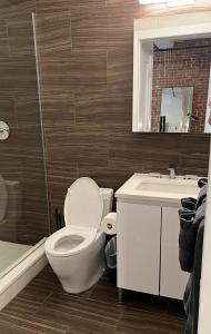 a bathroom with a toilet and a sink and a mirror at Large 3 bedroom in Flatiron in New York