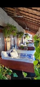 a bedroom with two beds and potted plants at Casa Cactus Praia in Macau
