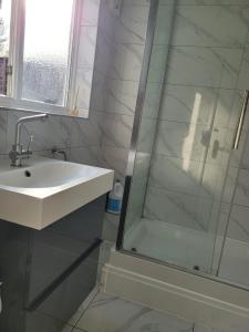a bathroom with a sink and a shower at Abakwa House in Kingsthorpe