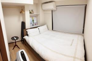 a small bedroom with a bed in a small room at Shinjuku private homestay max 10ppl in Tokyo