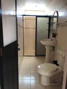 a bathroom with a toilet and a sink at Santísimo Hostal Boutique in Oaxaca City