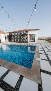 a swimming pool in the middle of a house at Hattah Palace View in Hatta