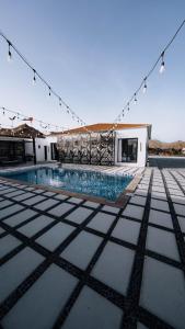 a swimming pool with lights on top of a building at Hattah Palace View in Hatta