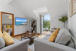 a living room with two couches and a table at Stunning Sea View Whole Home In Torbay Close To Beach in Torquay