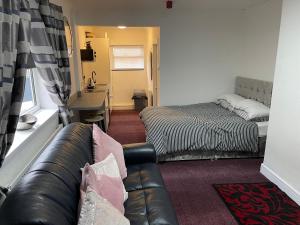a living room with a couch and a bed at Apartments Azalea Terrace in Sunderland