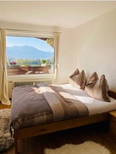 a bedroom with a bed with a large window at Apartment Sunset am Wolfgangsee in Strobl