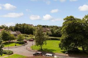 a green park with cars parked in a driveway at Geddes View in East Kilbride