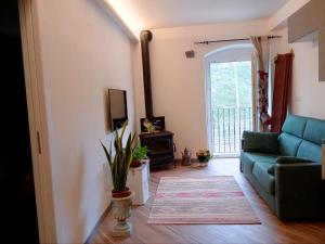 a living room with a blue couch and a television at Il Nido delle Rondini in Levanto