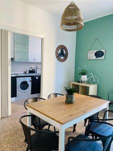 a kitchen and dining room with a table and chairs at Jane's Apartment Rental in Pisa
