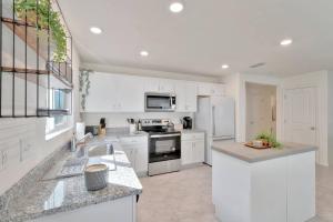 a kitchen with white cabinets and white appliances at Serene Sarasota Residence * By th Beach & Airport! in Sarasota