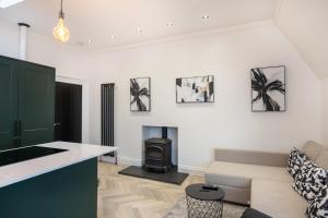 uma sala de estar com um sofá e um fogão em Luxury Apartment - Portobello em Edinburgo