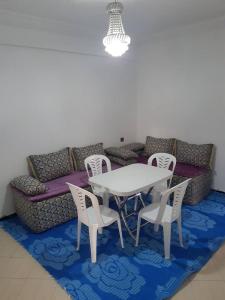 a table and chairs in front of a couch at Family House in Agadir