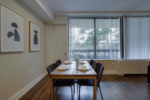 een eetkamer met een tafel en stoelen en een groot raam bij Great Condo for a Comfortable Stay @Crystal City in Arlington