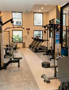 a gym with several treadmills and machines in a room at São Paulo Mercure Moema Times Square - Flat DIAMOND in Sao Paulo