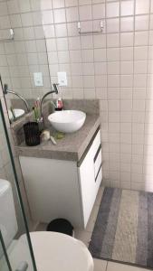 a bathroom with a sink and a toilet at Completo com Ar-condicionado in Recife