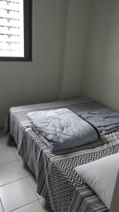 two beds sitting next to each other in a room at Completo com Ar-condicionado in Recife