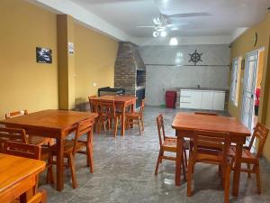 a dining room with wooden tables and wooden chairs at APART SOFIA in Termas de Río Hondo