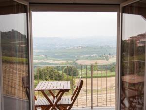 a view from the balcony of a house with a table at B&B Alba in Langhe in Verduno
