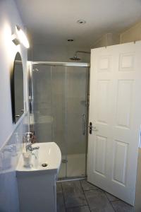 a bathroom with a shower and a sink and a shower at The Landmark in Cork
