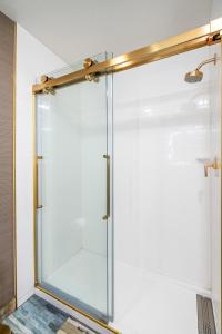 a shower with a glass door in a bathroom at 3 Palms Tucson North Foothills in Tucson