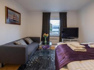 a living room with two beds and a couch at Aurora Dream House Apartment with free parking in Tromsø