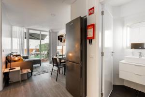 a kitchen with a refrigerator and a dining room at Patio in Central Porto in Porto