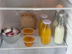 a refrigerator filled with lots of food and drinks at Okauia Lodge in Matamata