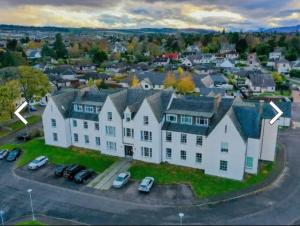 an aerial view of a large white house at The Highland Hideout in Inverness