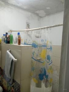 a bathroom with a shower curtain that has fish on it at Rocinha House in Rio de Janeiro