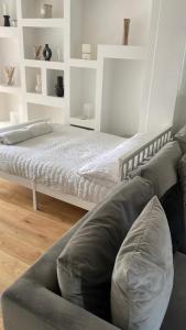 a living room with a bed and a couch at The Chill Zone Sleeps 4 in London