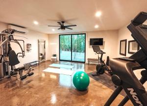 a gym with exercise equipment and a ceiling fan at The Yucca Hotel in Desert Hot Springs