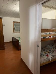 a room with two bunk beds and a hallway at Dolomiti Di Brenta in Ronzone