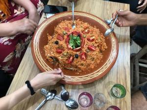un piatto di cibo su un tavolo di legno di Moroccan Family House ad Agadir