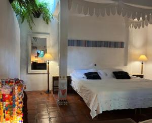 a bedroom with a large bed and a couch at Oca House in Búzios