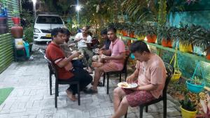 a group of people sitting in chairs eating food at GREEN VIEW HOME STAY in Siliguri