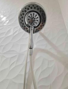 a shower head is hanging from a ceiling at convenient to live and travel（A）separate entrance in Vancouver