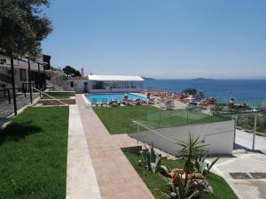 a resort with a swimming pool and the ocean at Hotel Rene in Skiathos