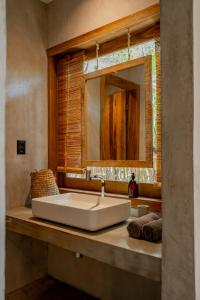 a bathroom with a sink and a mirror at Villa Mango Jeri in Jericoacoara