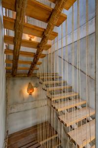 a staircase in a house with a wooden ceiling at Villa Mango Jeri in Jericoacoara