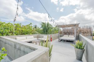an outdoor patio with chairs and a gazebo at Villa Mango Jeri in Jericoacoara