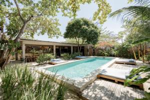 a swimming pool in the backyard of a house at Villa Mango Jeri in Jericoacoara