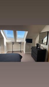 a bedroom with a bed and a desk and a tv at A Castle View in Keiss