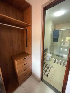 a bathroom with a walk in shower and a toilet at Aluguel Apto. Triplex Guaramiranga. in Guaramiranga +10 photos