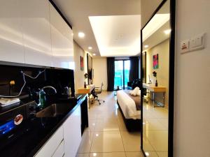 a kitchen with a sink and a living room at TopGenting RosyColdSuite4Pax @GrdIonDelmn in Genting Highlands