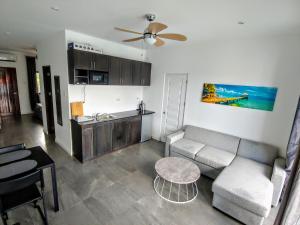 a living room with a couch and a table and a kitchen at Bohol Jewel Resort in Dauis