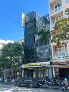 a black car parked in front of a building at LION 9 HOTEL in Can Tho