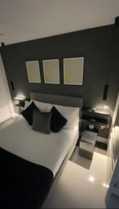 a bedroom with a large bed with two pillows at The Privacy Annex Balham in London