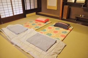 a room with two mats on the floor with towels at Private stay 120years old Japanese-style house in Okinoshima