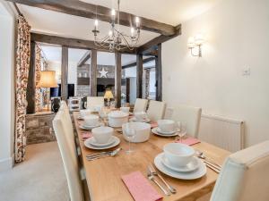 a dining room with a wooden table and chairs at The Carriage House in Llanwenarth