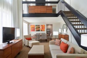 a living room with a couch and a tv at Delta Hotels by Marriott Toronto Airport & Conference Centre in Toronto